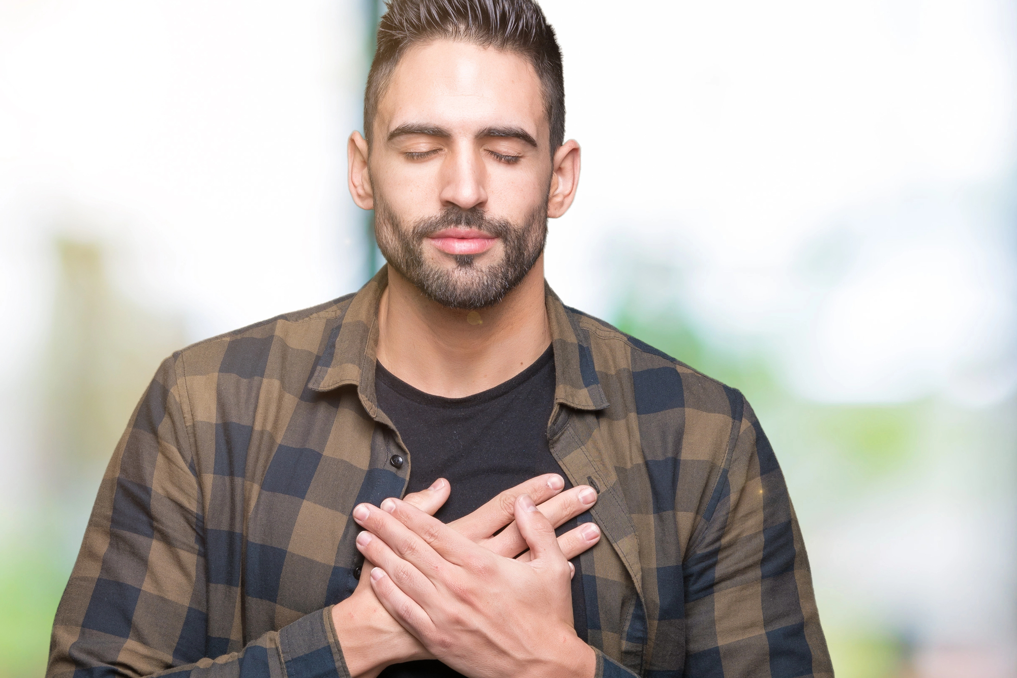 handsome man hands on chest grateful